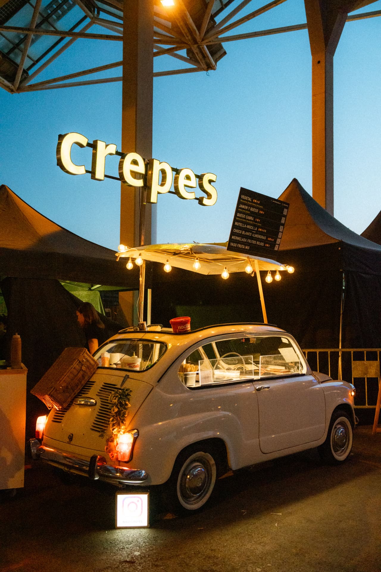 Festoon-lit crepes van at an evening market